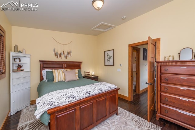 bedroom with dark hardwood / wood-style flooring