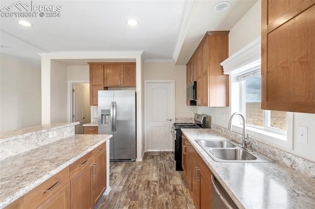 kitchen with light stone countertops, appliances with stainless steel finishes, sink, dark hardwood / wood-style flooring, and ornamental molding