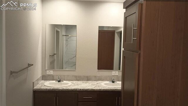 bathroom with a shower and vanity