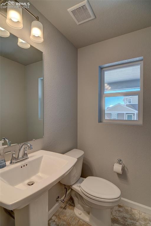 bathroom with tile flooring, sink, and toilet