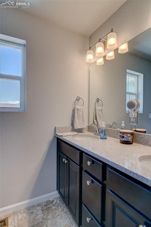 bathroom featuring tile floors and vanity