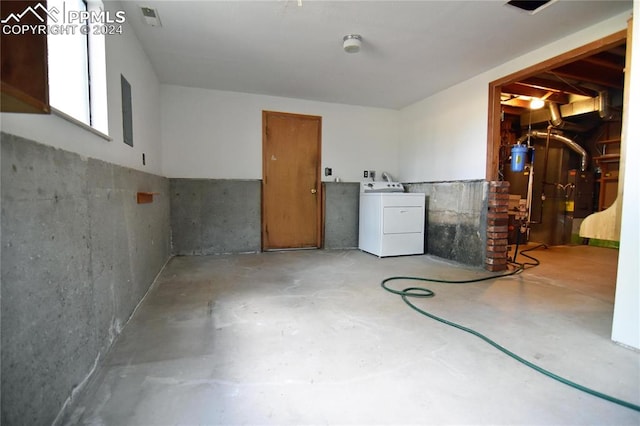 basement featuring water heater and washer / clothes dryer