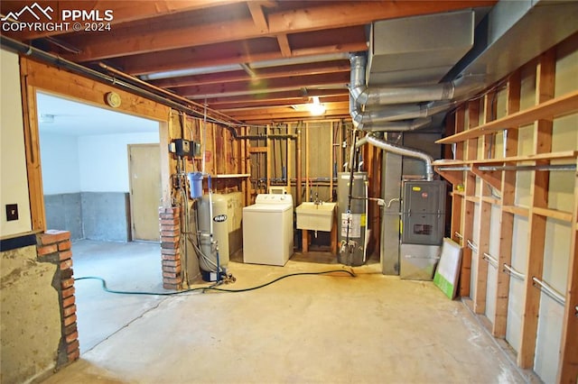 basement with sink, washer / dryer, and water heater