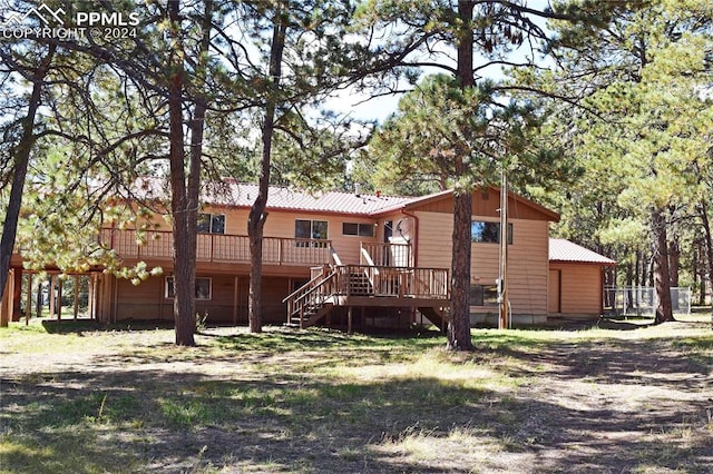 rear view of property featuring a deck