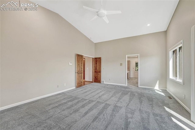 unfurnished room featuring ceiling fan, light carpet, and high vaulted ceiling