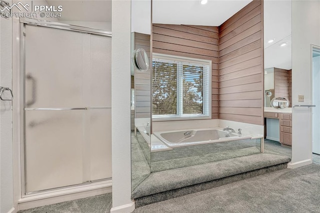 bathroom with wooden walls, separate shower and tub, and vaulted ceiling