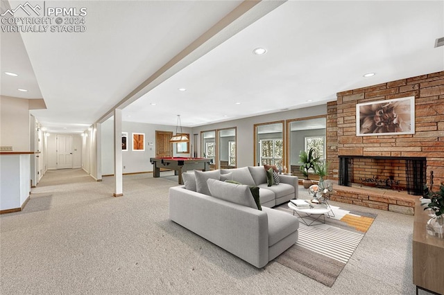 living room with light colored carpet, billiards, and a stone fireplace