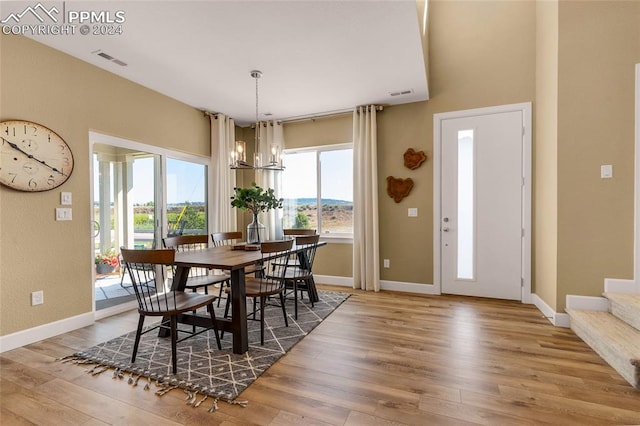 dining room featuring wood-type flooring and a notable chandelier