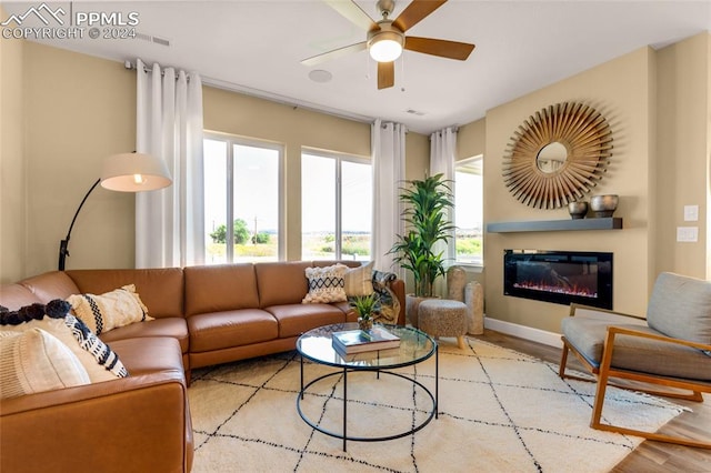 living room featuring light wood-type flooring and ceiling fan