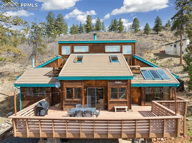 rear view of property with a patio area and outdoor lounge area