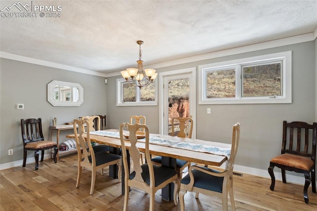 dining room featuring ornamental molding, light hardwood / wood-style flooring, a chandelier, and a textured ceiling