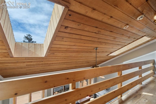 details featuring a skylight, wooden ceiling, and light hardwood / wood-style flooring