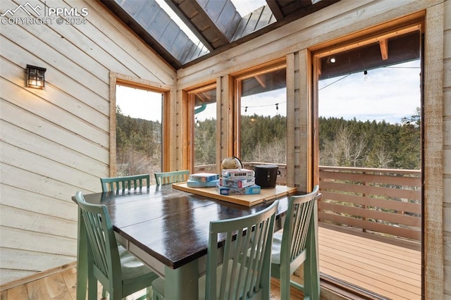 sunroom with lofted ceiling with skylight