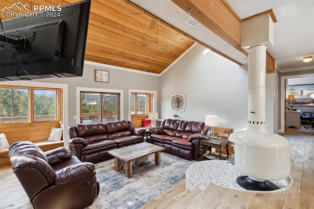 living room with crown molding, light hardwood / wood-style floors, ornate columns, and lofted ceiling