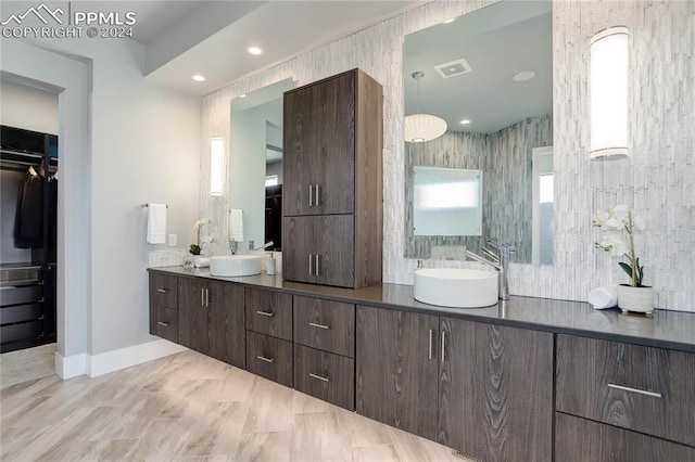 bathroom featuring tile walls, tile floors, and double sink vanity