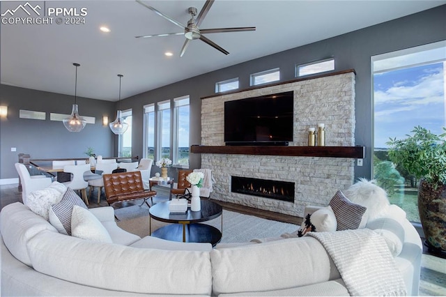 living room featuring ceiling fan and hardwood / wood-style flooring