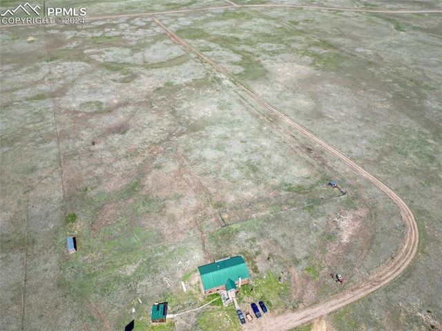 birds eye view of property with a rural view