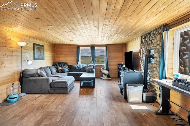 living room with wood ceiling, wood walls, and hardwood / wood-style flooring