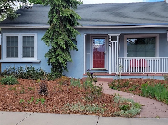 property entrance with covered porch