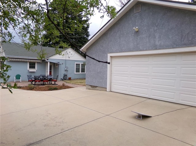 view of side of property with a patio