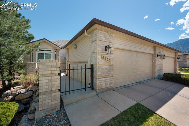 view of front of house featuring a garage and a mountain view