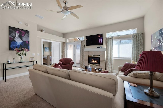 4529 Songglen Cir, Colorado Springs, CO 80906 - living room with carpet flooring, a tiled fireplace, and ceiling fan