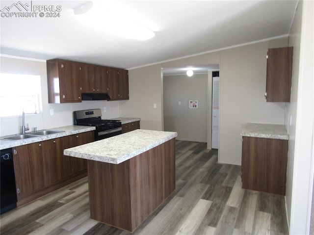 kitchen with a kitchen island, range hood, sink, stainless steel gas stove, and wood-type flooring