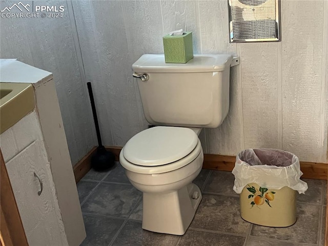 bathroom with toilet and tile flooring