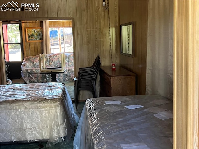 bedroom featuring wooden walls