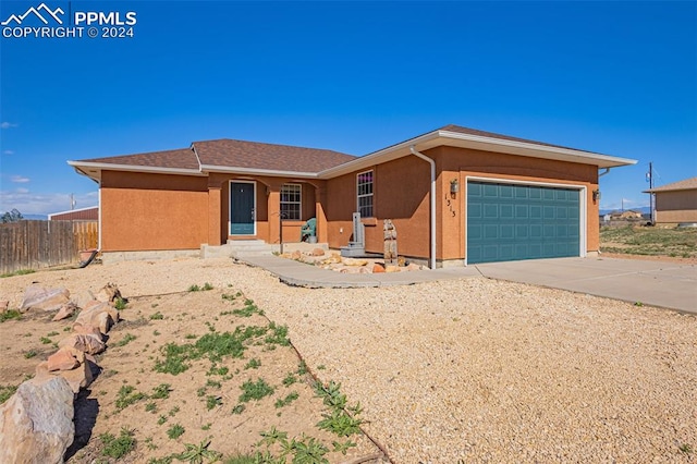 ranch-style house featuring a garage