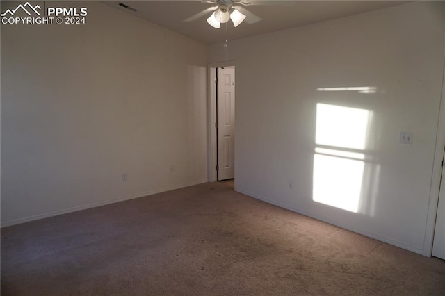 empty room featuring carpet flooring and ceiling fan