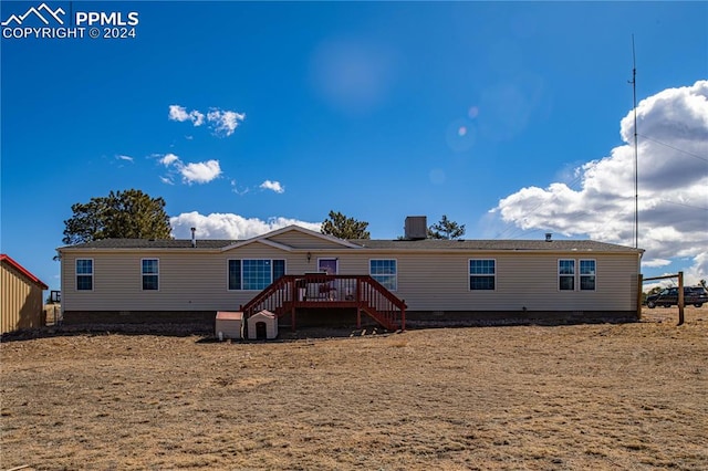 back of property featuring a deck