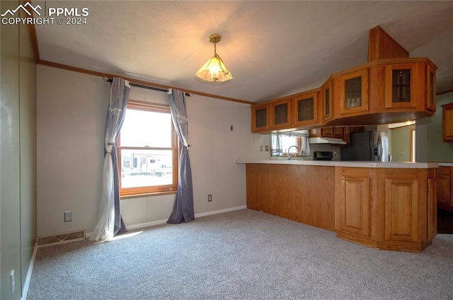 kitchen featuring sink, stainless steel refrigerator with ice dispenser, kitchen peninsula, hanging light fixtures, and light colored carpet