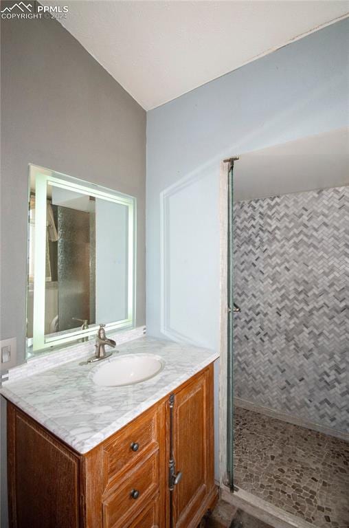 bathroom featuring vanity and a tile shower