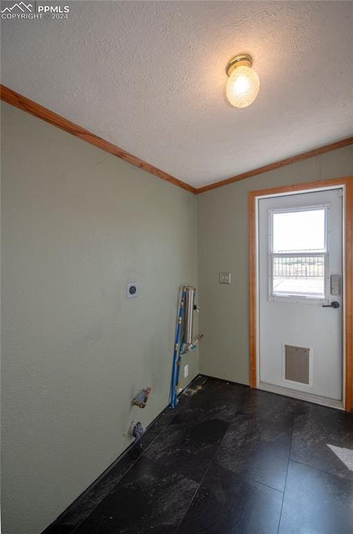 washroom featuring crown molding, hookup for an electric dryer, and a textured ceiling