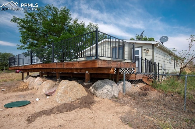 view of side of home featuring a wooden deck