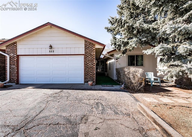 ranch-style home featuring a garage