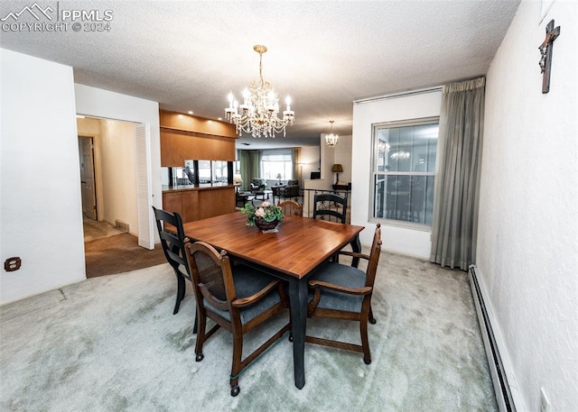 dining space featuring a textured ceiling, light carpet, an inviting chandelier, and a baseboard heating unit