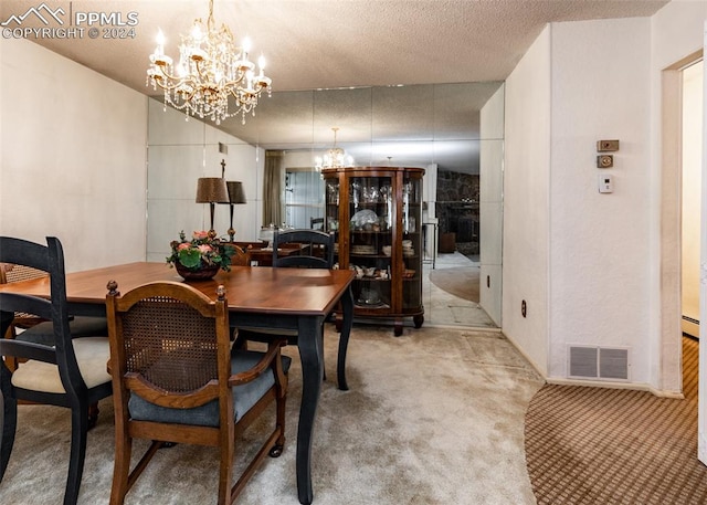 dining room featuring a chandelier, light carpet, and a textured ceiling