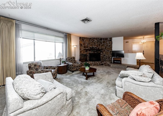 living room with an inviting chandelier, light carpet, a textured ceiling, and a fireplace