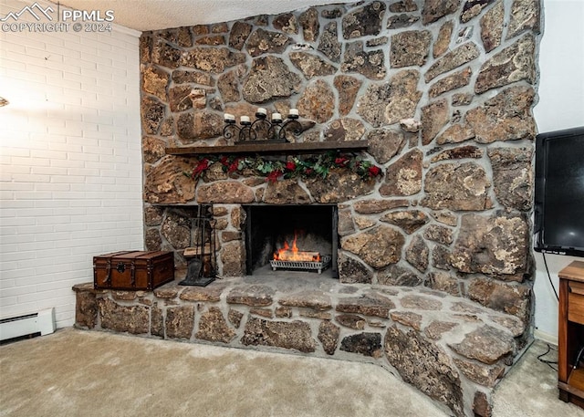 interior details featuring carpet, a fireplace, a baseboard radiator, and a textured ceiling