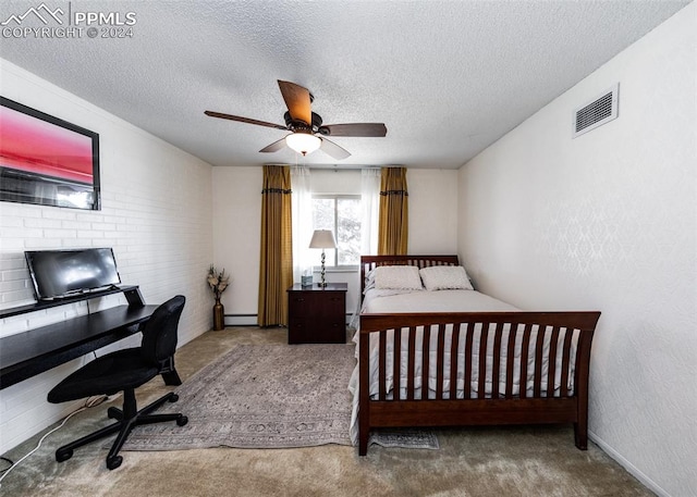 bedroom featuring ceiling fan, dark carpet, brick wall, and a textured ceiling