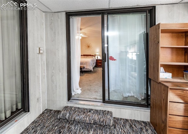 interior space with carpet floors and ceiling fan