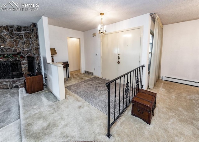 foyer entrance with a baseboard radiator, a chandelier, a stone fireplace, light colored carpet, and a textured ceiling