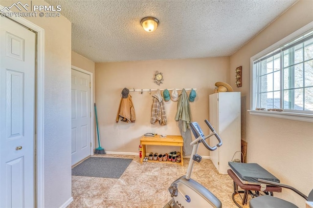 exercise area with a textured ceiling