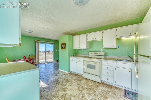 kitchen featuring a textured ceiling, white cabinetry, sink, and white appliances