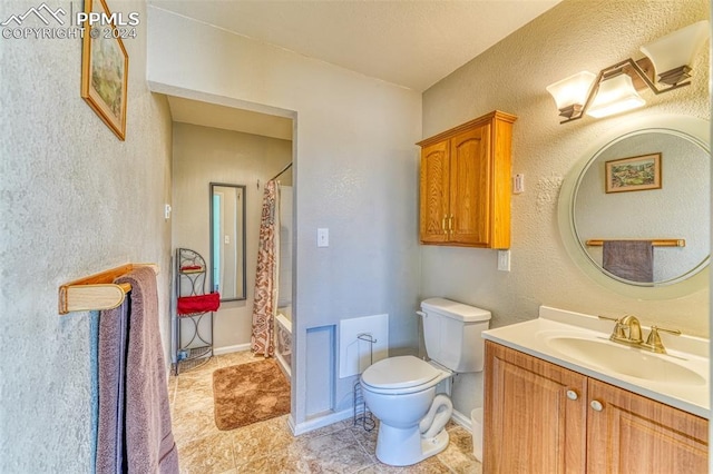 full bathroom with shower / tub combo with curtain, vanity, and toilet