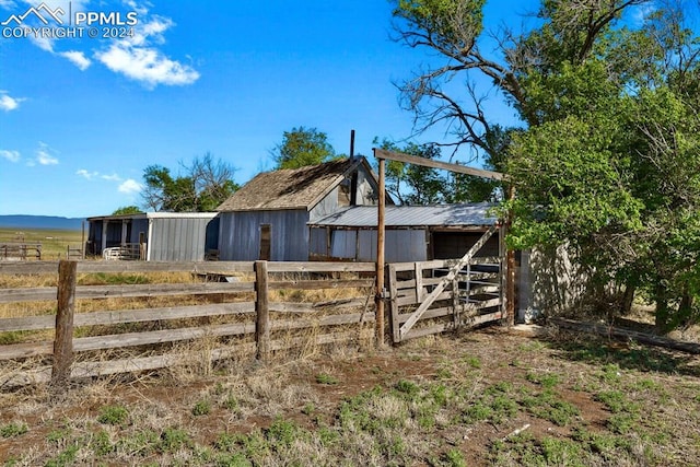 exterior space with a rural view and an outdoor structure