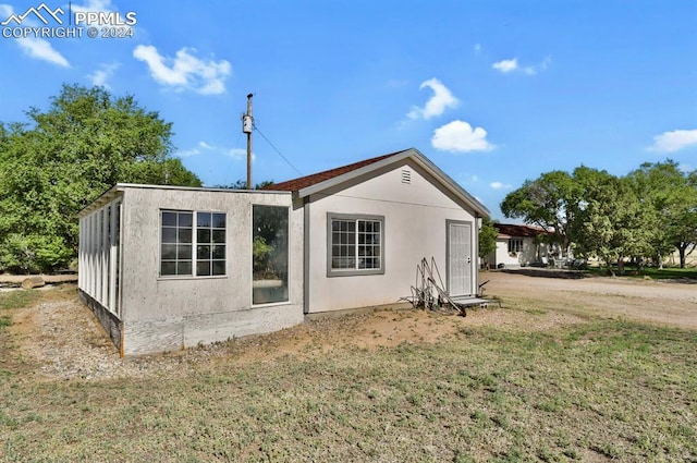 rear view of property with a lawn