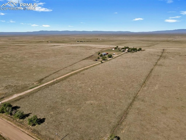 birds eye view of property featuring a mountain view and a rural view